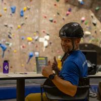 The competition director/ official time keeper/ safety officer giving 2 thumbs up about the new Ultima Thule helmet created by the event sponsor Higher Ground